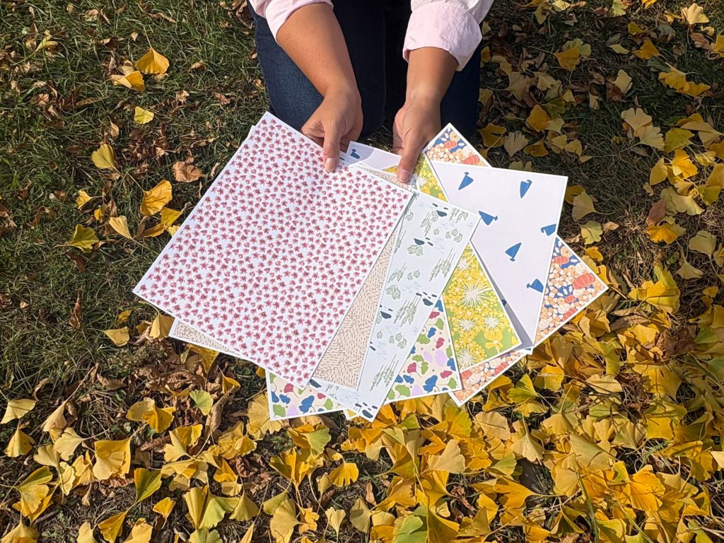 Pattern swatches photographed over bright yellow gingko leaves.